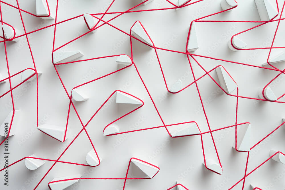 Vitamin D Deficiency and Eczema: Unraveling the Connection 2 Interweaving red strings on white background